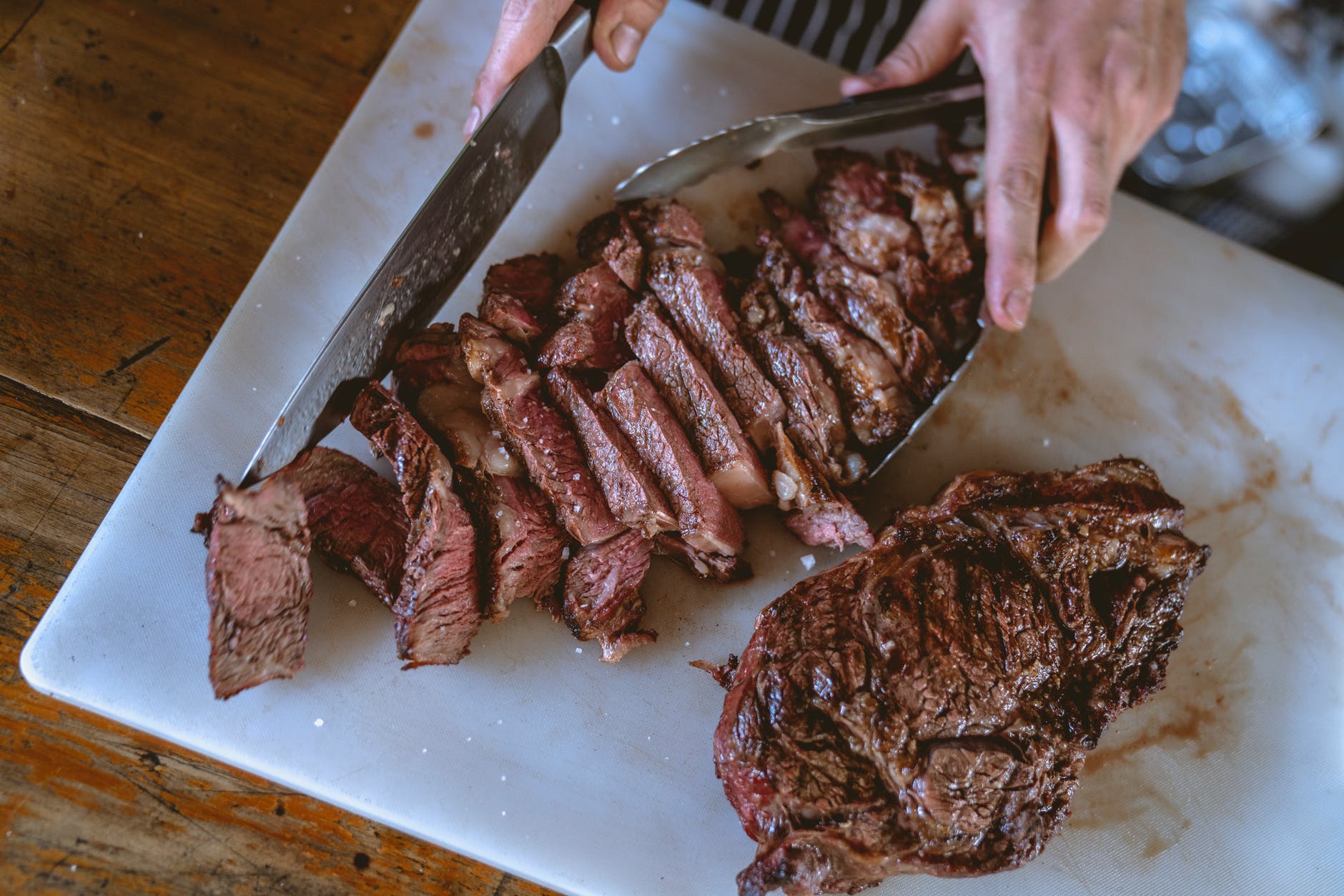 close up shot of a person slicing cooked meat